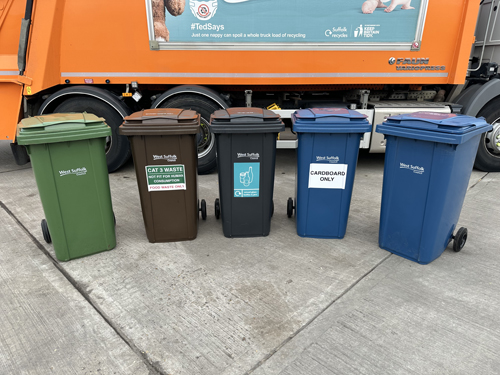 Five waste and recycling bins in front of a bin lorry