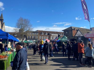 Image of busy market in the sunshine icon