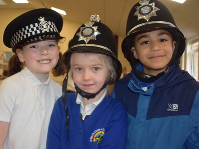 Students trying on police hats