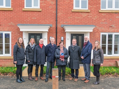 West Suffolk councillors, officers and representatives from Havebury Housing Partnership outside the new affordable rent and social rent homes in Bury St Edmunds, part delivered with funds from the council's redevelopment of The Old Post Office