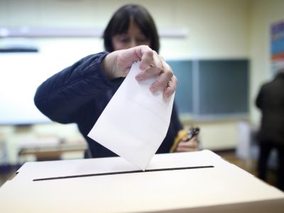 Image of person voting at a polling station