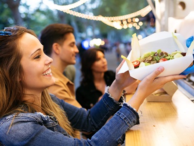 Street trading - the image shows people buying food from a food stall icon